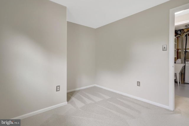 empty room with light colored carpet and baseboards