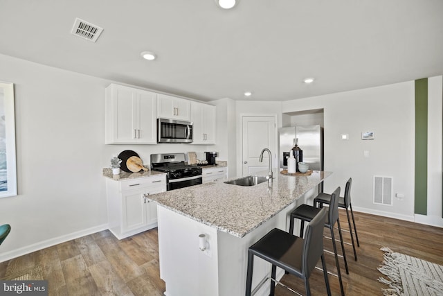 111 Yurok Ct, Winchester, VA 22602 - kitchen with light stone countertops, visible vents, stainless steel appliances, and a sink