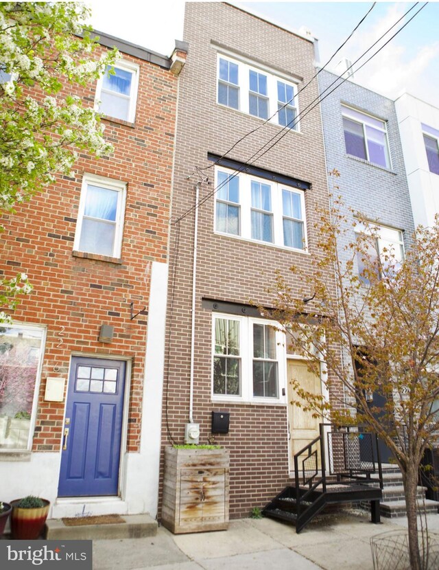 townhome / multi-family property with brick siding