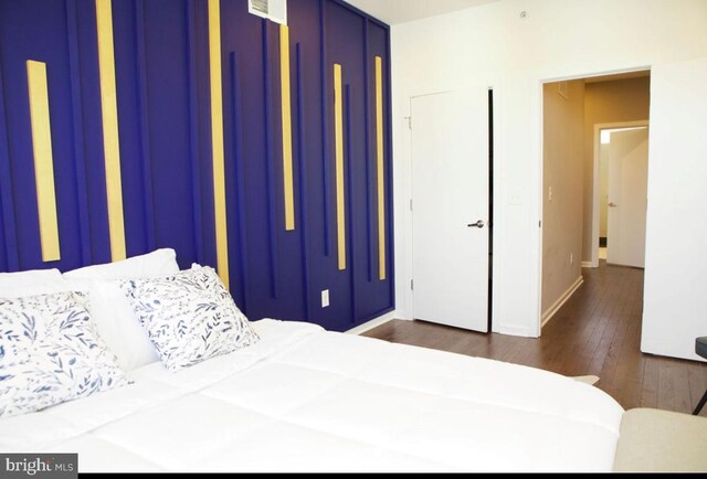 bedroom with baseboards and dark wood-style floors