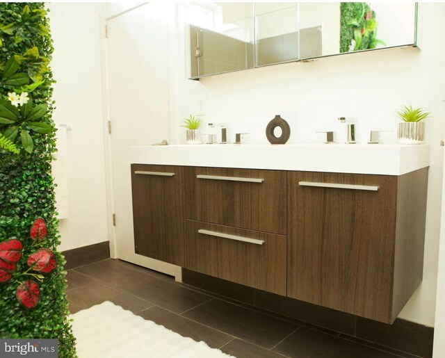 bathroom featuring tile patterned flooring and vanity