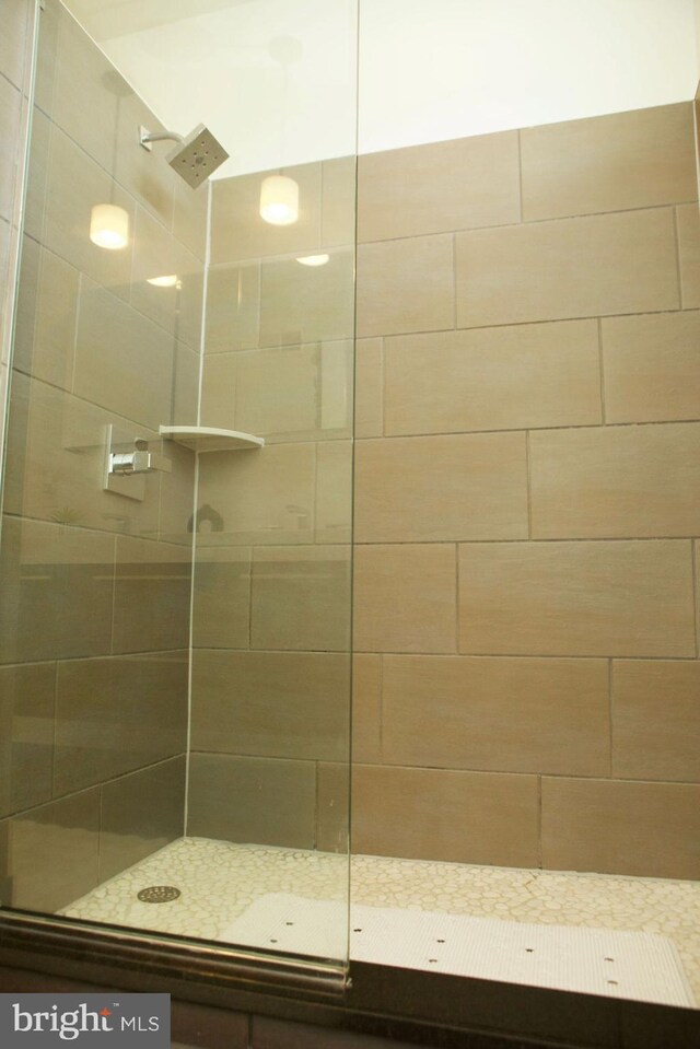 bathroom with a tile shower