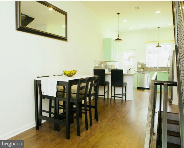 dining room with baseboards, recessed lighting, and dark wood finished floors