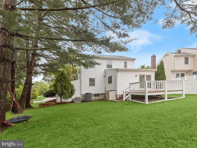 3826 Perryhurst, Nottingham, MD 21236 - rear view of house with a deck, a chimney, a lawn, and central AC unit
