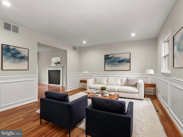 3826 Perryhurst, Nottingham, MD 21236 - living area featuring light wood-style flooring, recessed lighting, a wainscoted wall, and a decorative wall