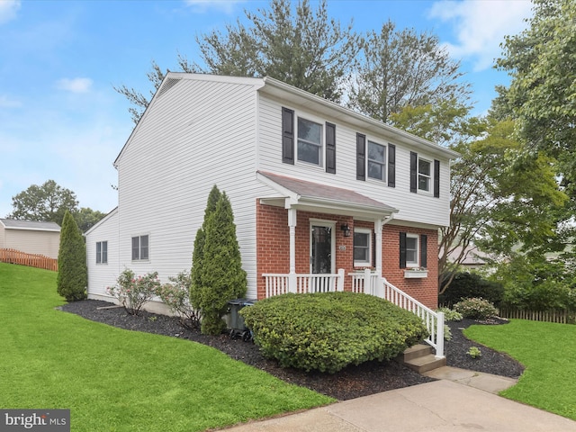 3826 Perryhurst, Nottingham, MD 21236 - view of front facade featuring a front yard, brick siding, and covered porch