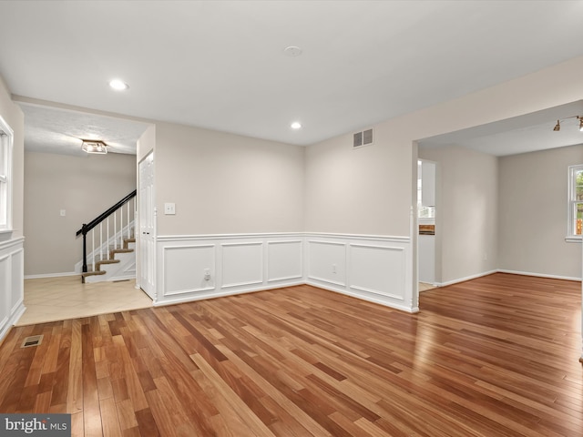 3826 Perryhurst, Nottingham, MD 21236 - spare room with light wood-type flooring, stairway, recessed lighting, and wainscoting