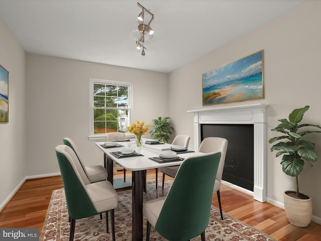 3826 Perryhurst, Nottingham, MD 21236 - dining area featuring light wood-style floors, baseboards, and a fireplace