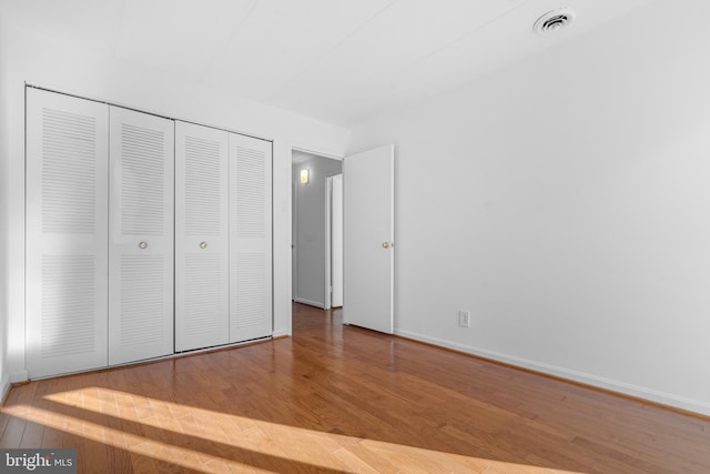 2648 Redcoat Dr Unit 99 1C, Alexandria, VA 22303 - unfurnished bedroom with baseboards, wood finished floors, visible vents, and a closet