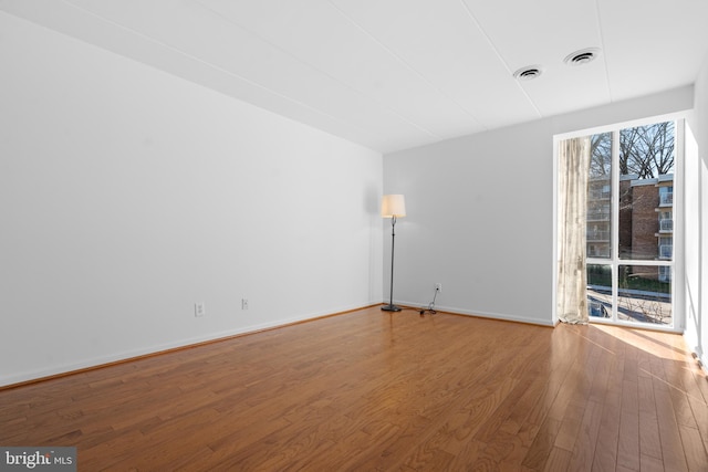 2648 Redcoat Dr Unit 99 1C, Alexandria, VA 22303 - unfurnished room with wood finished floors, visible vents, and baseboards