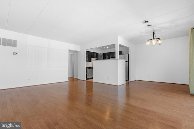 2648 Redcoat Dr Unit 99 1C, Alexandria, VA 22303 - unfurnished living room featuring visible vents, baseboards, wood finished floors, and an inviting chandelier