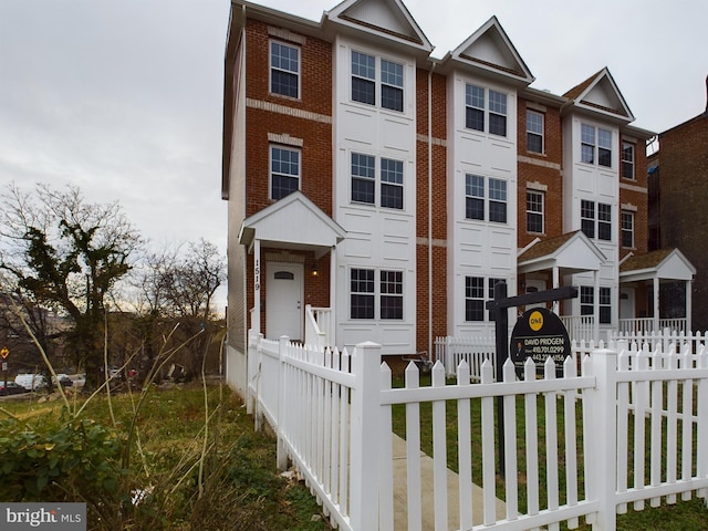 1519 E Chase St, Baltimore, MD 21213 - townhome / multi-family property with brick siding and a fenced front yard