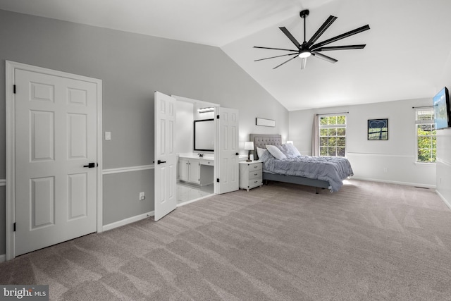 bedroom featuring ceiling fan, vaulted ceiling, baseboards, connected bathroom, and light carpet