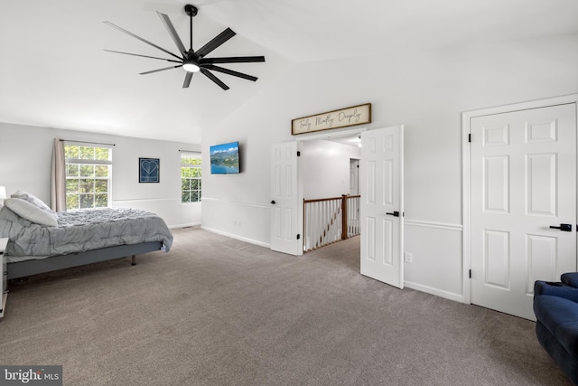 carpeted bedroom featuring baseboards, ceiling fan, and high vaulted ceiling