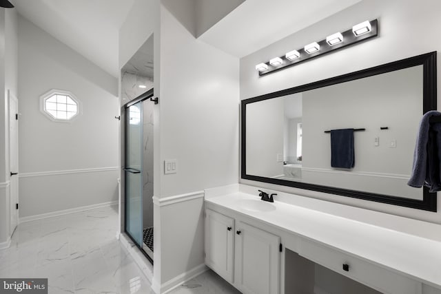 bathroom featuring baseboards, a marble finish shower, marble finish floor, and vanity