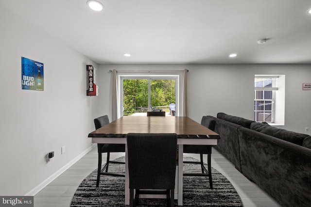 dining room featuring baseboards, recessed lighting, and light wood-style flooring