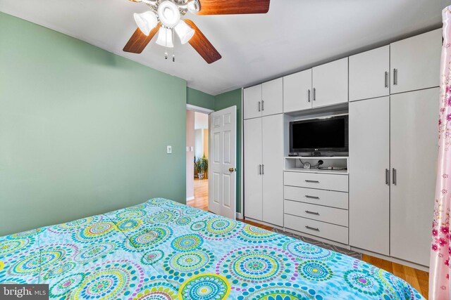 bedroom with wood finished floors and a ceiling fan