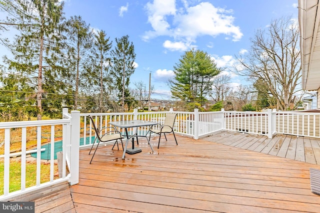 wooden terrace with outdoor dining space