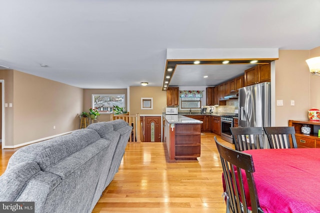 dining area featuring recessed lighting, plenty of natural light, and light wood finished floors