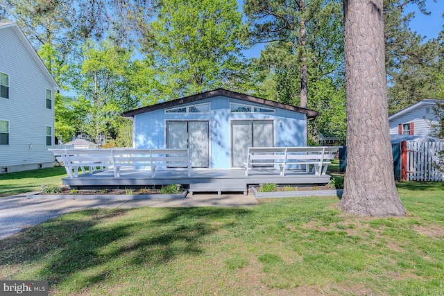 7010 Dover Ave, North Beach, MD 20714 - view of front facade with a wooden deck and a front lawn