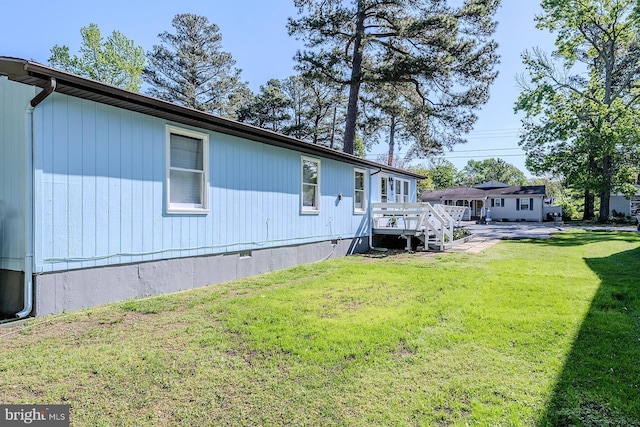 7010 Dover Ave, North Beach, MD 20714 - view of side of home featuring a yard, a deck, and crawl space
