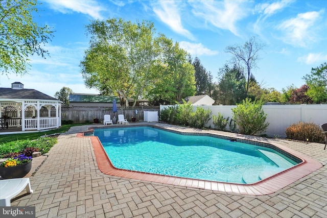 view of swimming pool with a fenced in pool, a patio, a gazebo, and a fenced backyard