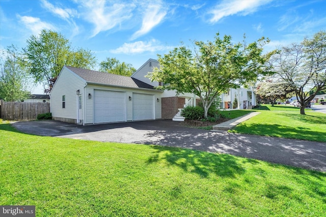 view of front of home with fence, a shingled roof, aphalt driveway, a garage, and a front yard