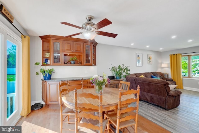 dining room featuring recessed lighting, baseboards, ceiling fan, and light wood finished floors