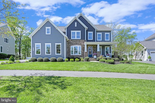 41972 Paddock Gate Pl, Ashburn, VA 20148 - craftsman-style home featuring stone siding, a front yard, and covered porch