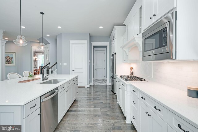 41972 Paddock Gate Pl, Ashburn, VA 20148 - kitchen featuring appliances with stainless steel finishes, a sink, white cabinetry, light countertops, and recessed lighting