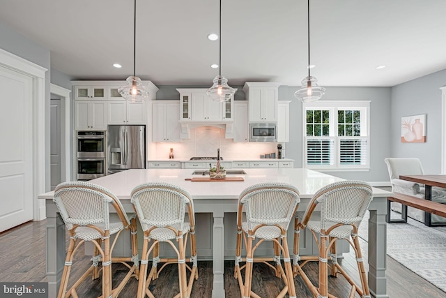 41972 Paddock Gate Pl, Ashburn, VA 20148 - kitchen with appliances with stainless steel finishes, light countertops, a sink, recessed lighting, and a large island with sink