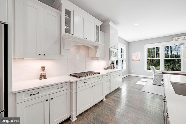 41972 Paddock Gate Pl, Ashburn, VA 20148 - kitchen with stainless steel appliances, white cabinets, tasteful backsplash, dark wood-style floors, and baseboards