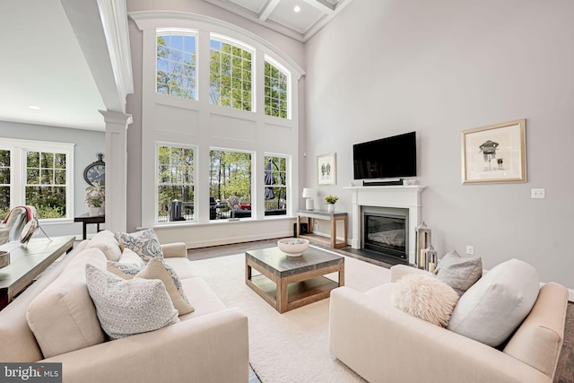 41972 Paddock Gate Pl, Ashburn, VA 20148 - living room featuring ornate columns, a high ceiling, a fireplace with flush hearth, beamed ceiling, and recessed lighting