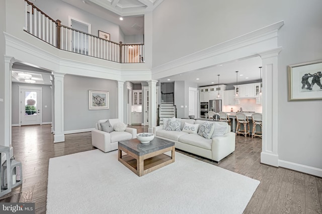 41972 Paddock Gate Pl, Ashburn, VA 20148 - living area featuring ornate columns, wood finished floors, stairway, baseboards, and recessed lighting