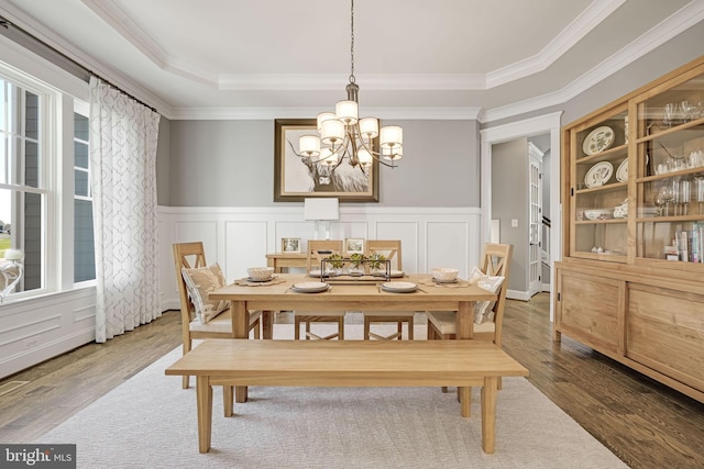 41972 Paddock Gate Pl, Ashburn, VA 20148 - dining space featuring ornamental molding, a chandelier, a tray ceiling, wood finished floors, and wainscoting