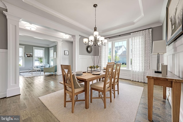 41972 Paddock Gate Pl, Ashburn, VA 20148 - dining area featuring decorative columns, a decorative wall, wainscoting, crown molding, and wood finished floors
