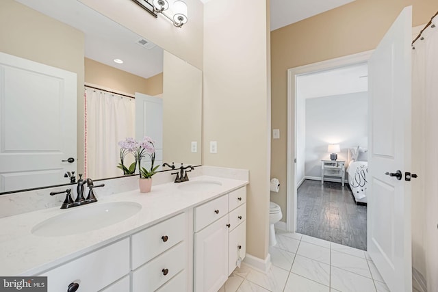 41972 Paddock Gate Pl, Ashburn, VA 20148 - full bath featuring toilet, double vanity, connected bathroom, and baseboards