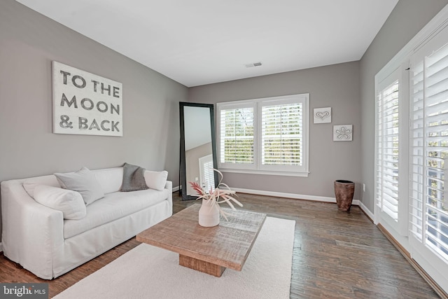41972 Paddock Gate Pl, Ashburn, VA 20148 - living room featuring healthy amount of natural light, wood finished floors, and baseboards