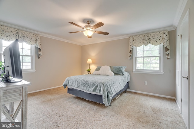 carpeted bedroom with baseboards, ornamental molding, and ceiling fan
