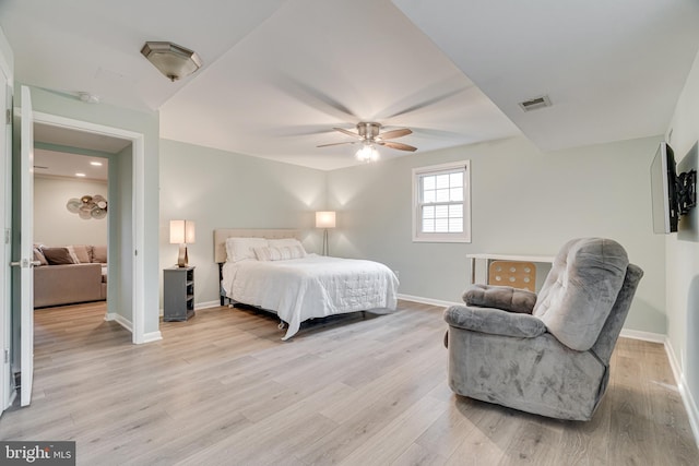 bedroom with visible vents, a ceiling fan, baseboards, and light wood-type flooring