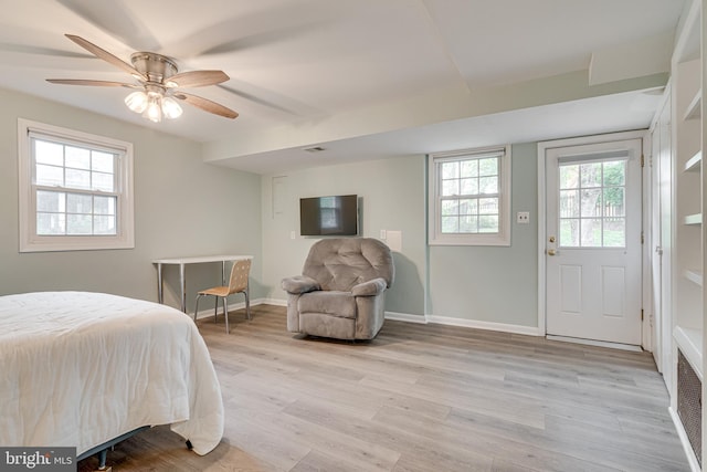 bedroom with light wood-style floors, baseboards, and ceiling fan