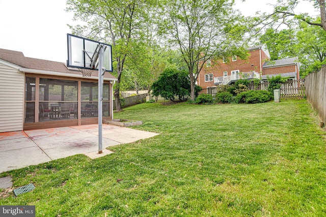 view of yard with a sunroom, a fenced backyard, and a patio