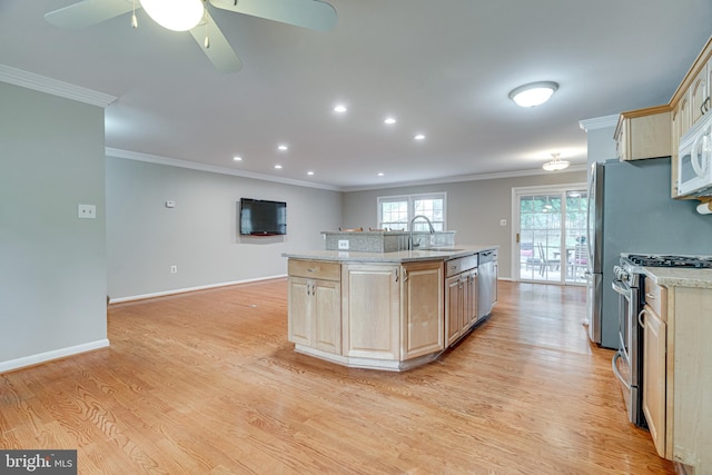kitchen featuring crown molding, light brown cabinets, stainless steel gas stove, and a sink