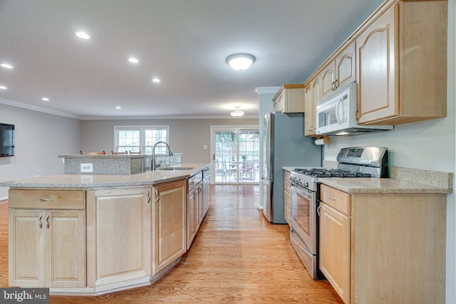 kitchen featuring ornamental molding, light brown cabinets, stainless steel gas range oven, a sink, and light wood finished floors