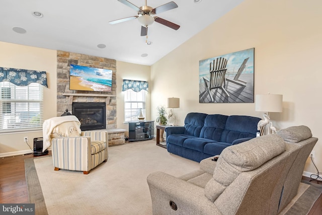 living room with a ceiling fan, a wealth of natural light, wood finished floors, and baseboards