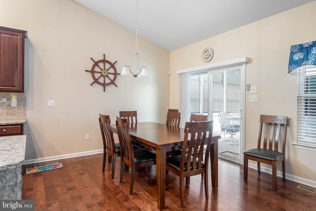 dining space with visible vents, dark wood-style flooring, and baseboards