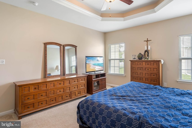 bedroom featuring a tray ceiling, ceiling fan, light colored carpet, and baseboards