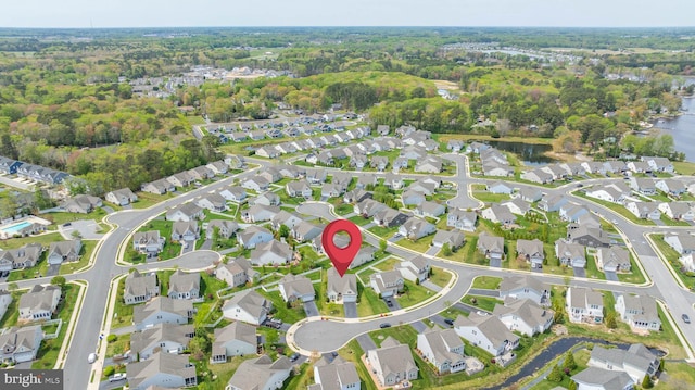 birds eye view of property featuring a wooded view and a residential view