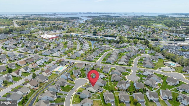 drone / aerial view featuring a water view and a residential view