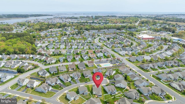 drone / aerial view with a residential view and a water view